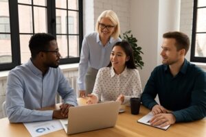 Diverse team collaborating in a modern workplace to assess culture fit.